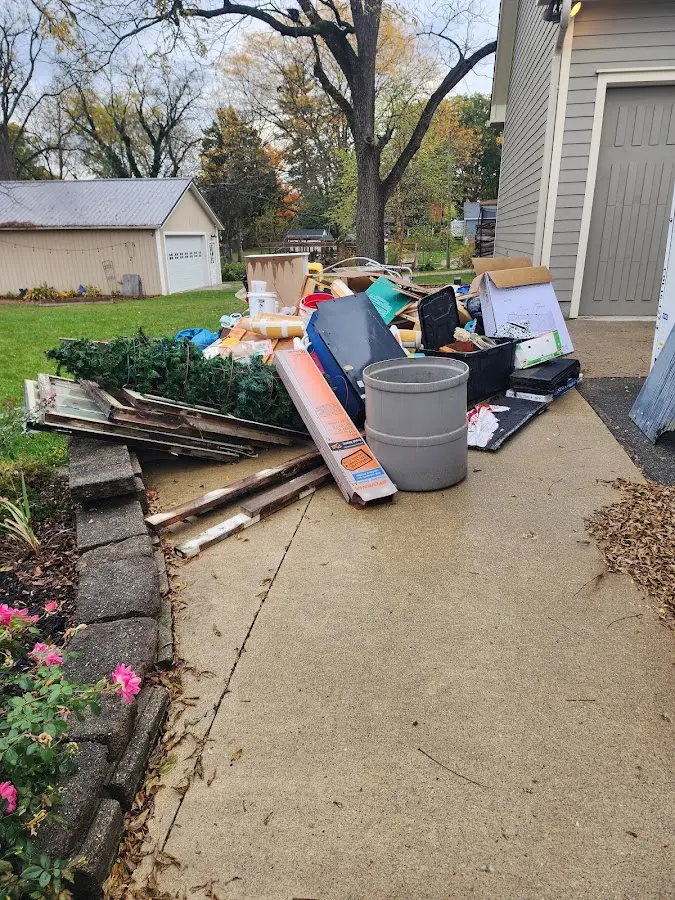 Dumpster being loaded with debris for 12 Yard Dumpster Rental in Davidson